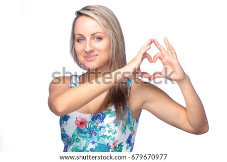 pretty young woman making heart sign on white background