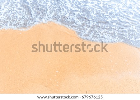 Soft wave with blue ocean on sandy beach. Empty space can be used as background for display or montage your top view products.