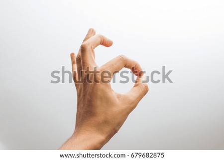 human hand showing okey sign 