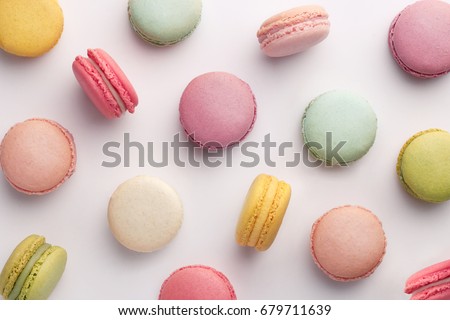Macarons pattern on white background. Colorful french desserts. Top view Royalty-Free Stock Photo #679711639