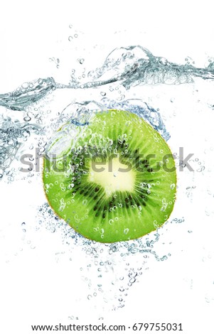 fresh kiwi falling in water