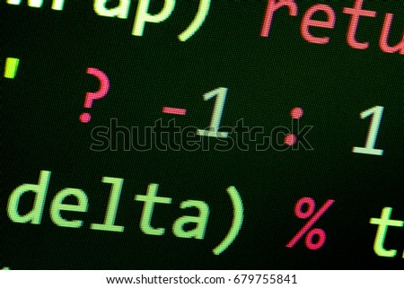 Closeup view of computer screen with green source code