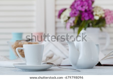 Home Interior with Coffee cup books white flower on table wooden