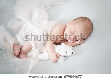 Two weeks old baby to sleep with teddy bear  Royalty-Free Stock Photo #679844677