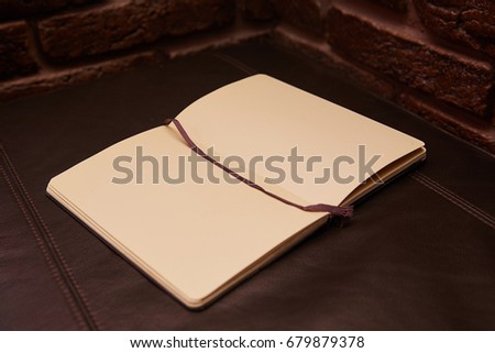 Open Notepad or sketchbook lying on background