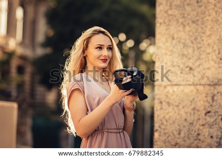 amazed young beautiful girl using new VR technology VR gear on market amazing sights on oculus headset 3D video glasses VR headset and 360 video on the street with beautiful autumn sun light colors