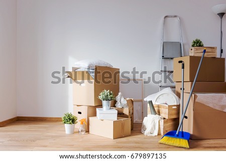 Room full of box containers and stuff for cleaning. Move, packing and unpacking. Royalty-Free Stock Photo #679897135