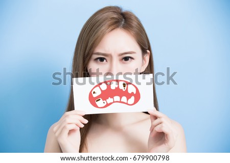 woman take tooth billboard and feel bad on the blue background Royalty-Free Stock Photo #679900798
