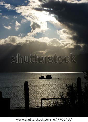 Light and darkness at the sea.
A lonely boat coming back from fishing and an amazing ocean view.
Picture taken in Puerto Cisnes, Chilean Patagonia