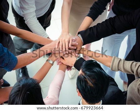 hands of business team on workspace background top view ,