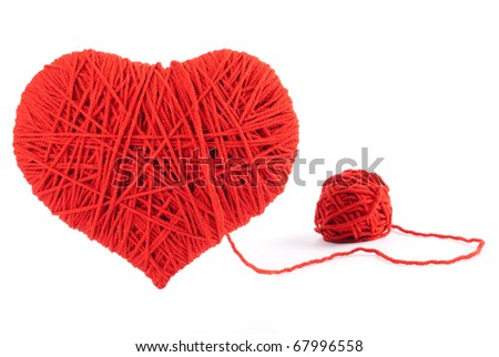Red heart shape symbol made from wool isolated on white background. Valentine