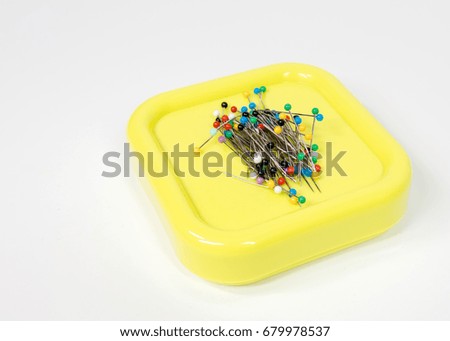 Metal straight pins on magnetic pincushion Royalty-Free Stock Photo #679978537