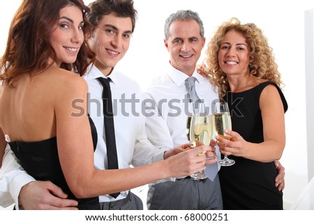 Group of friends cheering with glasses of champagne