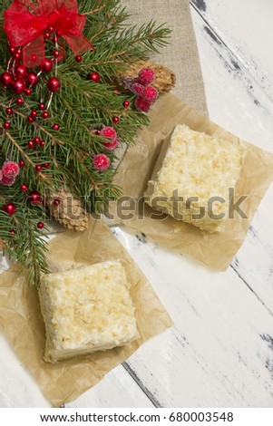 Napoleon cake with Christmas decoration on white wooden board