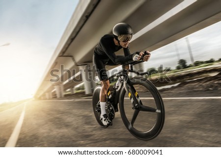 Asian men are cycling "time trial bike" in the morning Royalty-Free Stock Photo #680009041