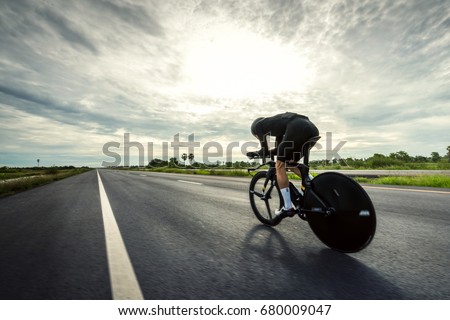 Asian men are cycling "time trial bike" in the morning Royalty-Free Stock Photo #680009047