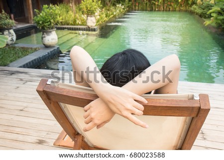 woman relaxing near the swimming pool at Thai resort