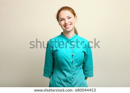 Young nurse posing on neutral background