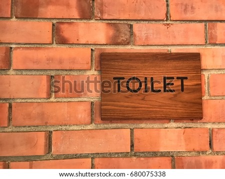 Vintage public toilet sign on the wall.