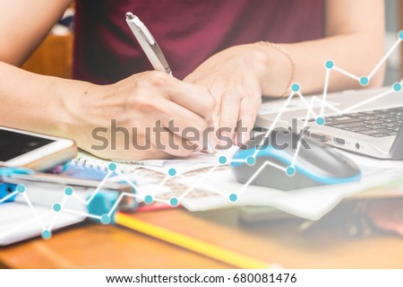 Working or purchase or invest online concept. Growth trading graph on hand using computer laptop