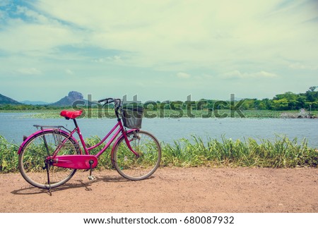 Instagram Effect Of the bicycle stands on a village road at Thalkote lake near Sigiriya. Renting a bicycle and cycling around Sigiriya village is the most popular way among the tourists 