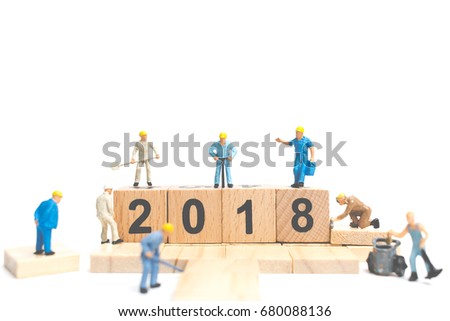 Miniature worker team building number on wooden block ,  Happy new year  2018