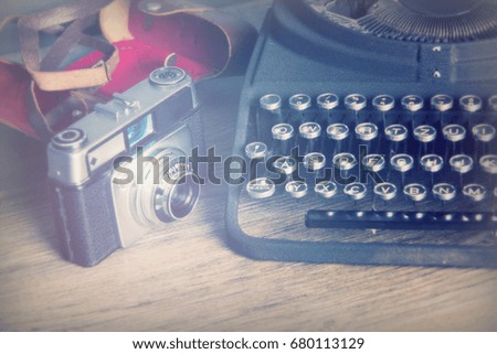 Old vintage retro camera with an old-fashioned typewriter