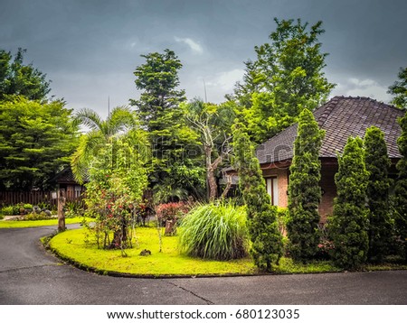Garden and holiday house on the vacation day on Chiang Rai, Thailand with rain cloud