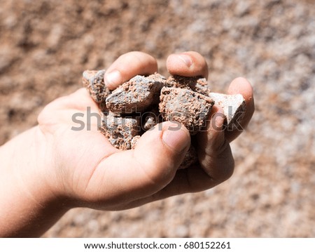 Building crushed stone with sand in hand