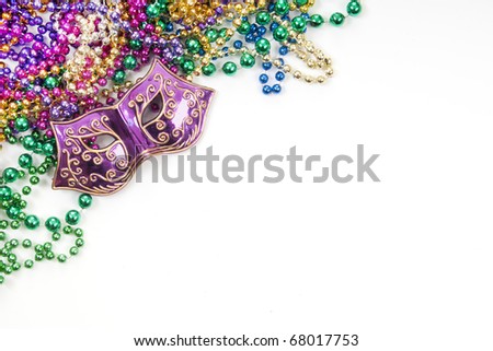 Mardi gras mask and beads in pile