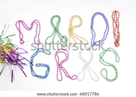 mardi gras written in throwing beads