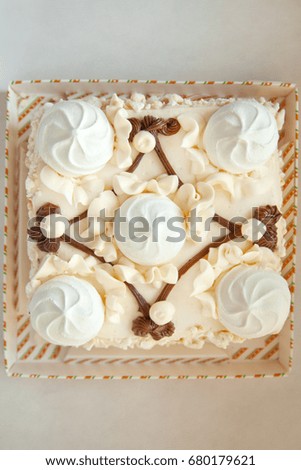 white meringue cake on white background top view
