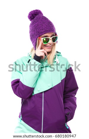 vertical picture, isolated on white, blonde pretty young caucasian woman in purple ski costume and sunglasses, hand on glasses