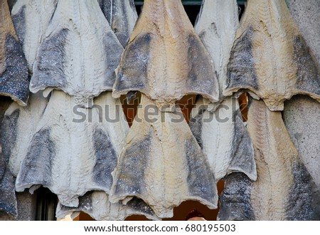 Salted cod hanging outside a shop in Porto, Portugal. Royalty-Free Stock Photo #680195503