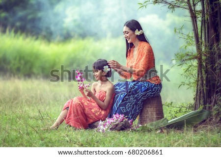 Balinese Lady strengthening beauty to each other. Royalty-Free Stock Photo #680206861