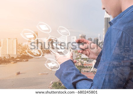 The abstract image of the business man holding the credit card and the smartphone with hologram. The concept of online shopping, online payment, financial and internet of things.