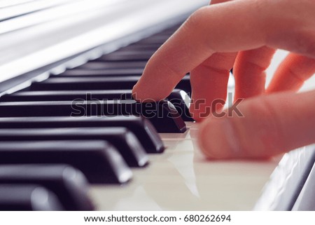 Close up view on a right hand playing the piano