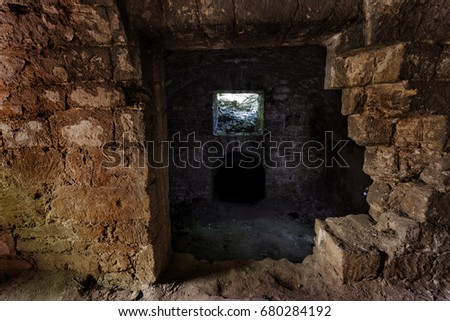 An old abandoned tunnel in an underground wine cellar. Entrance to catacombs. Dungeon An old stone fortress. As a creative background for staging dark design. Mystic interior of an ancient dungeon
