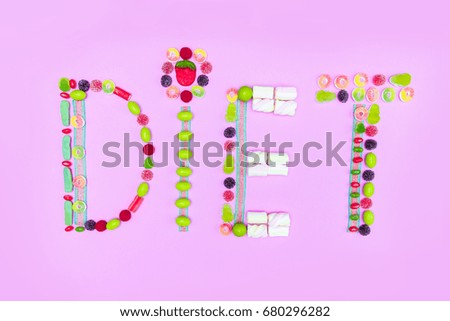 top view of diet word made of colorful sweets isolated on pink