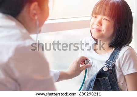 Professional general medical pediatrician doctor in white uniform gown listen lung and heart sound of Asia child patient with stethoscope: Physician check up Asian kid female after consult in hospital Royalty-Free Stock Photo #680298211
