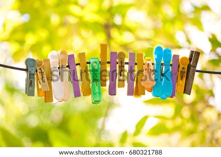 Colored plastic and wooden clothes pegs on the clothesline