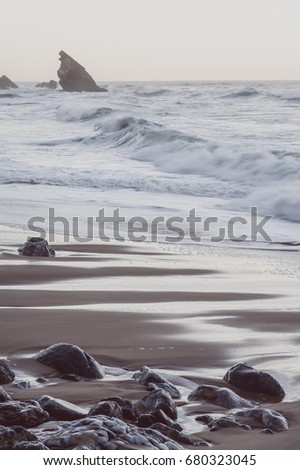Atlantic ocean beach with rocks. vintage toned picture