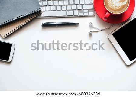 White office desk table with a lot of things tablet, laptop ,smartphone ,notepad and coffee cup notepad . Top view with copy space.

