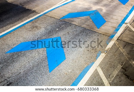 Arrow blue traffic symbols on street