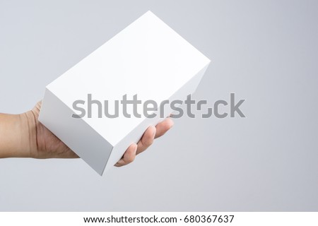 Hand holding blank white box give gift on white background Royalty-Free Stock Photo #680367637