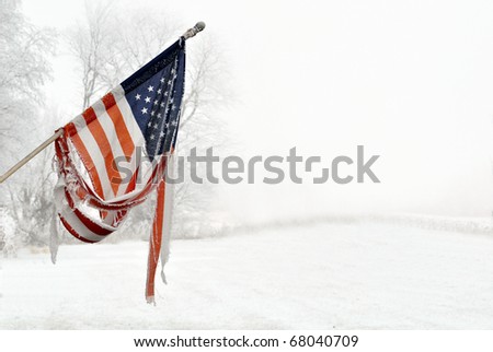 Old Vintage torn American Flag with frost and snow
