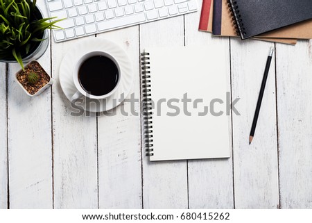 Empty notebook, computer and coffee on wooden table