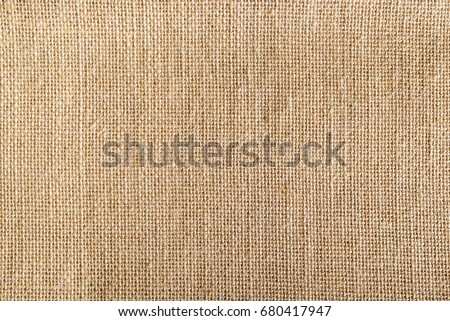 Top view of natural brown hessian cloth or gunny sack. Hessian cloth is an inexpensive fabric or garment made of hessian or burlap formed of jute, coarsely woven fabric. Abstract texture background Royalty-Free Stock Photo #680417947