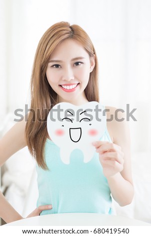 woman take cute tooth billboard at home