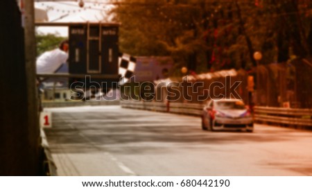 Blurred,Race cars on the track running into the finish line at high speed.